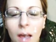 Amateur spouse wearing glasses receives messy cumshot in mouth and face