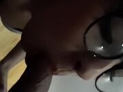 Sensual woman with glasses takes a fast facial cumshot